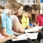 Teenage Students In Library Reading Books