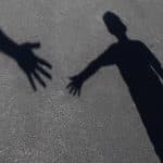 Shadow of two people reaching out