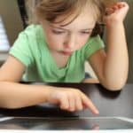child playing on tablet