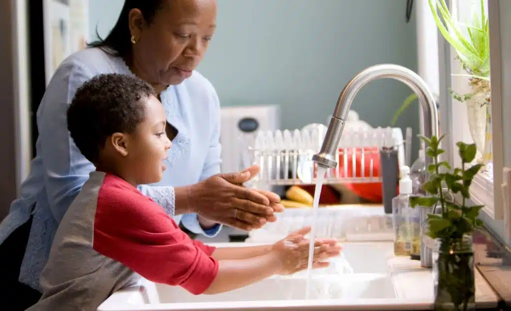 Parent and child washing hands