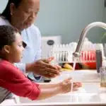 Parent and child washing hands